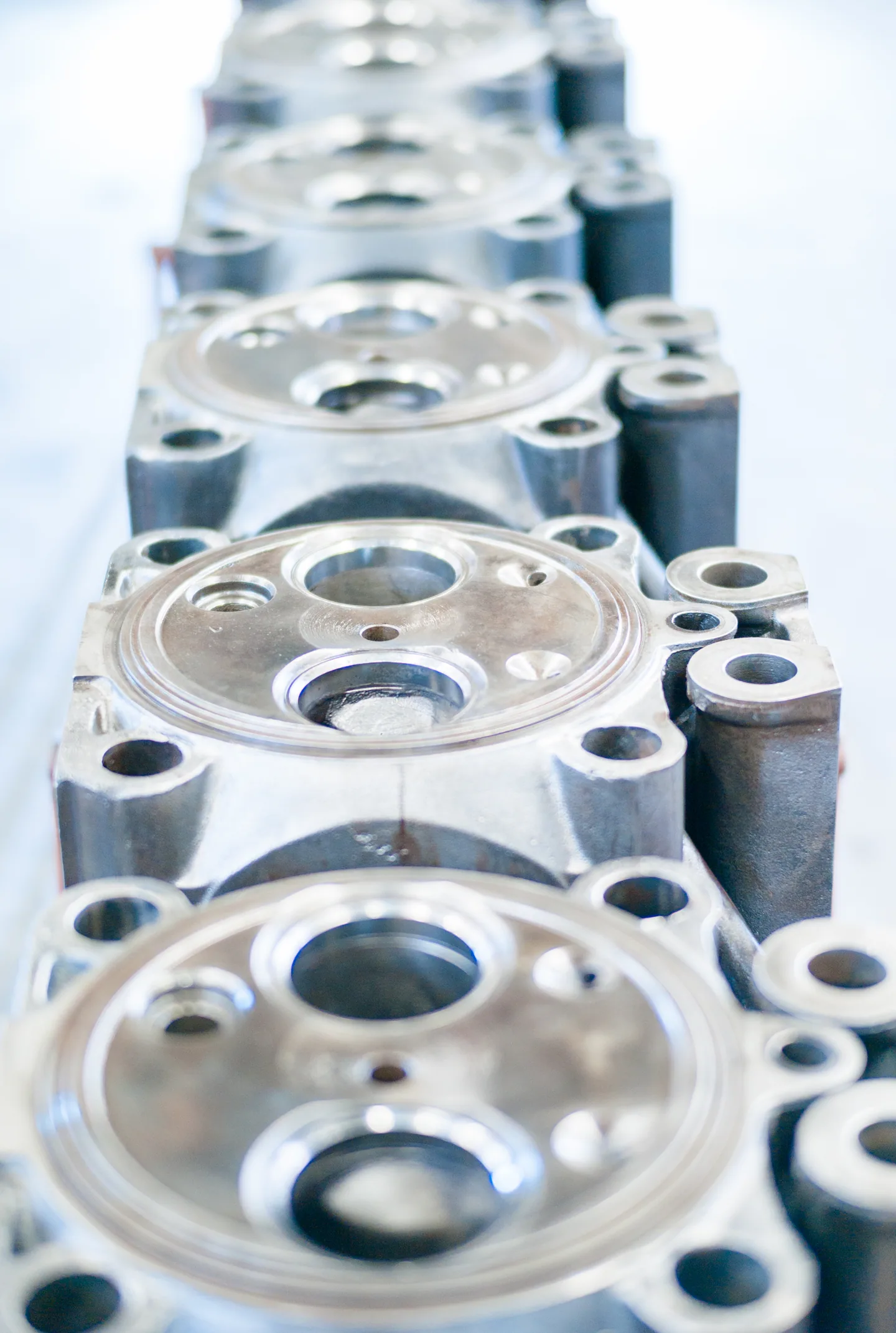 A row of machined cylinder heads.