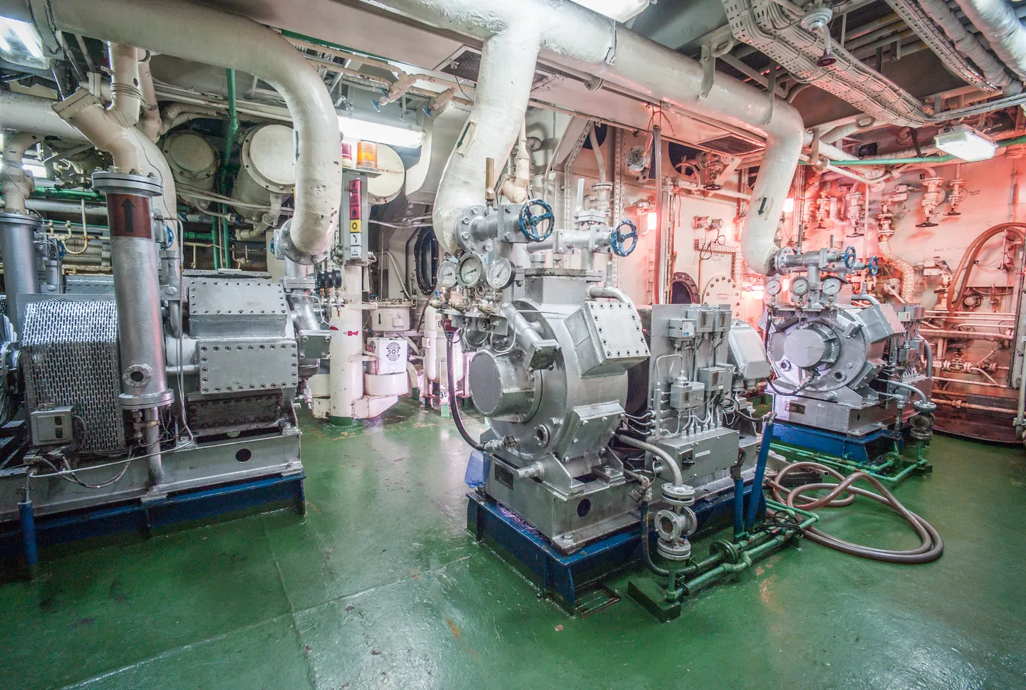 Machinery, pipes and pressure gauges in a ship’s engine room.