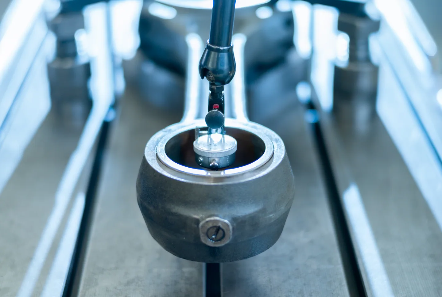 A measuring instrument checking a machined engine component.